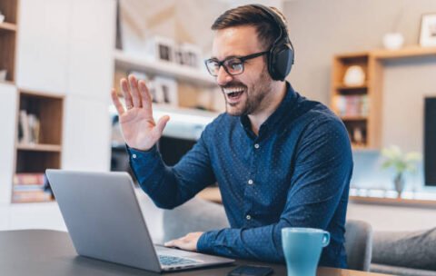 Handsome businessman having Video Conference at home